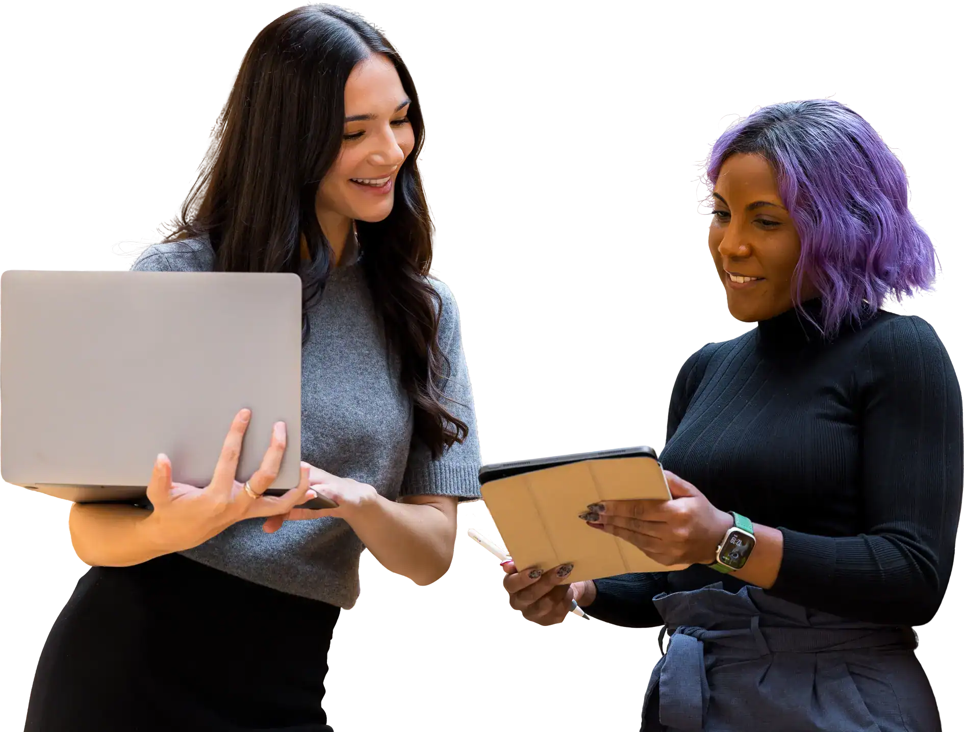 Two Marketing Guardians team members reviewing work together on a laptop and a tablet